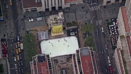 5.5K aerial stock footage of circling above the ice skating rink at Rockefeller Center in Midtown, New York City Aerial Stock Footage | AX120_189E