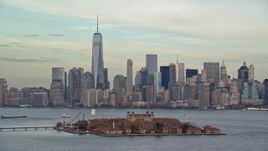 5.5K aerial stock footage orbit Ellis Island and Lower Manhattan skyline in Autumn, New York City Aerial Stock Footage | AX120_259E