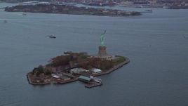 5.5K aerial stock footage slowly orbit the Statue of Liberty at twilight in Autumn, New York Aerial Stock Footage | AX121_012E