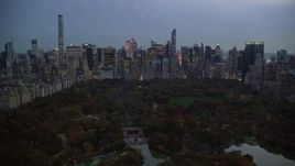 5.5K aerial stock footage of Midtown skyscrapers seen from The Lake in Central Park at twilight, New York City Aerial Stock Footage | AX121_098E