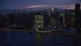 5.5K aerial stock footage approach UN Building in Midtown at Night from East River, New York City Aerial Stock Footage | AX121_144E