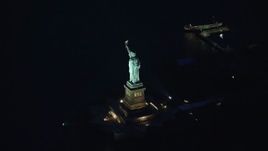 5.5K aerial stock footage orbit the Statue of Liberty at Night in New York Aerial Stock Footage | AX121_167