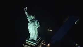 5.5K aerial stock footage a slow orbit above Statue of Liberty at Night in New York Aerial Stock Footage | AX121_168E