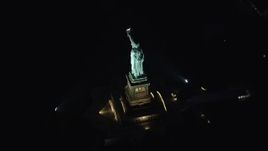 5.5K aerial stock footage approach the Statue of Liberty at Night in New York Aerial Stock Footage | AX121_195E