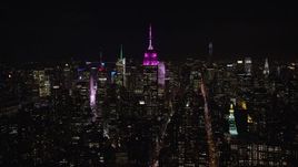 5.5K aerial stock footage of a wide orbit of the Empire State Building at Night in Midtown Manhattan, NYC Aerial Stock Footage | AX122_052E