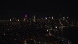5.5K aerial stock footage of Midtown Manhattan seen from the shore of the East River at Night, NYC Aerial Stock Footage | AX122_070E