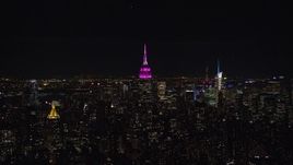 5.5K aerial stock footage orbit Empire State Building with pink light at Nighttime, Midtown, New York City Aerial Stock Footage | AX122_078E