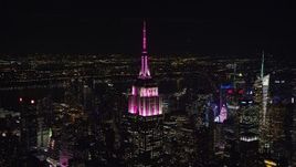 5.5K aerial stock footage orbit Empire State Building with red and white lighting at Night, Midtown, NYC Aerial Stock Footage | AX122_092