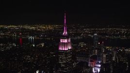 5.5K aerial stock footage orbit top of Empire State Building with pink and white light at Night, Midtown Manhattan, NYC Aerial Stock Footage | AX122_093E