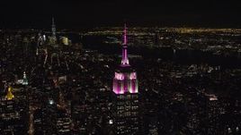 5.5K aerial stock footage orbit of the Empire State Building with striped lights at Night, Midtown, NYC Aerial Stock Footage | AX122_097E