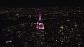 5.5K aerial stock footage circle the Empire State Building with pink and white lights at Night, Midtown, NYC Aerial Stock Footage | AX122_100E