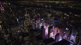 5.5K aerial stock footage of circling the Bank of America Tower toward the glow of Times Square at Night, Midtown, NYC Aerial Stock Footage | AX122_115E