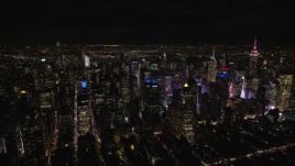 5.5K aerial stock footage of orbiting Midtown skyscrapers around Times Square at Night in New York City Aerial Stock Footage | AX122_129E