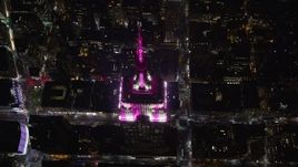 5.5K aerial stock footage approach the historic Empire State Building at tilt to the spire at Night, Midtown, New York City Aerial Stock Footage | AX122_194E