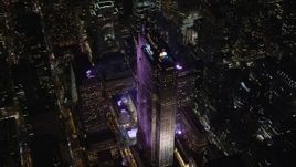 5.5K aerial stock footage of circling around Rockefeller Center with ice rink at Night in Midtown, NYC Aerial Stock Footage | AX122_202E
