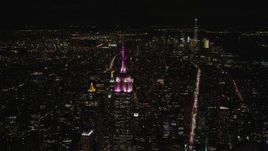 5.5K aerial stock footage orbit Empire State Building with view of Lower Manhattan at Night, New York City Aerial Stock Footage | AX122_213