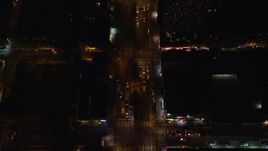 5.5K aerial stock footage of a bird's eye of heavy traffic off Williamsburg Bridge to Delancey Street at Night, Lower East Side, NYC Aerial Stock Footage | AX122_242E