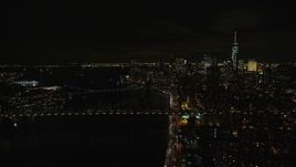 5.5K aerial stock footage of approaching the Manhattan and Brooklyn Bridge in Lower Manhattan at Night in NYC Aerial Stock Footage | AX122_258