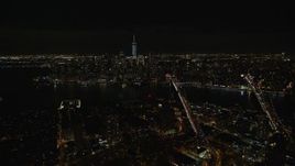 5.5K aerial stock footage fly over Brooklyn to approach bridges over East River and Lower Manhattan at Night, NYC Aerial Stock Footage | AX122_275E