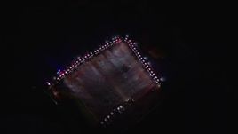 5.5K aerial stock footage of police cars with bright lights circling a parking lot on Wards Island at Night, New York City Aerial Stock Footage | AX123_027E
