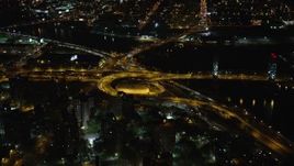 5.5K aerial stock footage of riverfront freeway interchange by Robert F. Kennedy Bridge at Night, Harlem, New York City Aerial Stock Footage | AX123_031