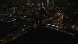 5.5K aerial stock footage of flying toward the Lower Manhattan skyline and the Brooklyn Bridge at night in NYC Aerial Stock Footage | AX123_105E