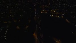 5.5K aerial stock footage of a reverse view of Southern State Parkway through Uniondale at Night in New York Aerial Stock Footage | AX123_167E