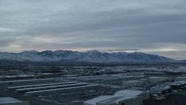 5.5K aerial stock footage of the Wasatch Range viewed from SLC International Airport at Sunrise in Winter, Utah Aerial Stock Footage | AX124_002