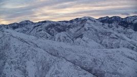 5.5K aerial stock footage approach Wasatch Mountains at Sunrise in Winter in Utah Aerial Stock Footage | AX124_022E