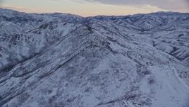 5.5K aerial stock footage a snowy mountain ridge at Sunrise in Wasatch Range, Utah Aerial Stock Footage | AX124_024E