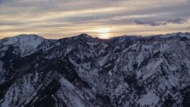 5.5K aerial stock footage of the sunrise over snowy winter Wasatch Range mountains in Utah Aerial Stock Footage | AX124_039