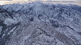 5.5K aerial stock footage fly over Mount Olympus with snow at winter sunrise in Utah Aerial Stock Footage | AX124_046