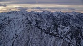 5.5K aerial stock footage approach snowy Wasatch Range mountains in winter at sunrise, Utah Aerial Stock Footage | AX124_054
