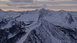 5.5K aerial stock footage orbit snowy Wasatch Range mountain ridges in winter at sunrise in Utah Aerial Stock Footage | AX124_067