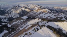 5.5K aerial stock footage of mountains with winter snow at sunrise in the Wasatch Range, Utah Aerial Stock Footage | AX124_101