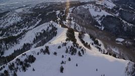 5.5K aerial stock footage approach snowy mountain ridge at sunrise in winter, Wasatch Range, Utah Aerial Stock Footage | AX124_103E