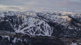 5.5K aerial stock footage of snow-covered Wasatch Range mountains at sunrise in Utah Aerial Stock Footage | AX124_107