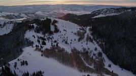 5.5K aerial stock footage approach snow-covered mountains at sunrise in Utah's Wasatch Range Aerial Stock Footage | AX124_114E