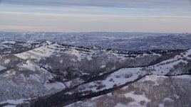 5.5K aerial stock footage of Wasatch Range mountain ridge with winter snow at sunrise in Utah Aerial Stock Footage | AX124_131E