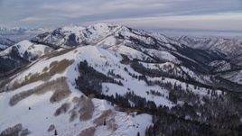 5.5K aerial stock footage fly over snowy ridge and trees in Utah's Wasatch Range at sunrise Aerial Stock Footage | AX124_141E