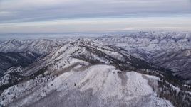 5.5K aerial stock footage of flying toward a ridge with winter snow at sunrise in the Wasatch Range, Utah Aerial Stock Footage | AX124_146