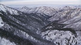 5.5K aerial stock footage of Wasatch Range snow mountains at sunrise in Utah Aerial Stock Footage | AX124_150