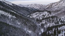 5.5K aerial stock footage flyby and over Wasatch Range mountains with winter snow at sunrise, Utah Aerial Stock Footage | AX124_151E