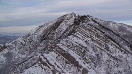 5.5K aerial stock footage approach Grandeur Peak with light snow at sunrise in Utah Aerial Stock Footage | AX124_169E