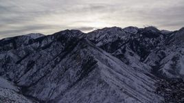 5.5K aerial stock footage flyby snow mountains in the Wasatch Range in winter at sunrise in Utah Aerial Stock Footage | AX124_180