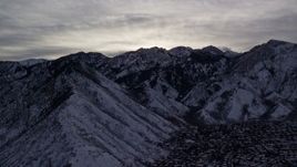 5.5K aerial stock footage of Wasatch Range snow mountains bordering suburbs at sunrise in Utah Aerial Stock Footage | AX124_181