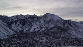 5.5K aerial stock footage of Mount Olympus and Salt Lake City suburbs with winter snow at sunrise in Utah Aerial Stock Footage | AX124_182E