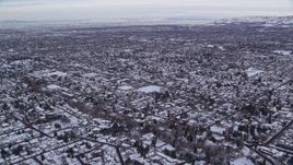 5.5K aerial stock footage fly over snowy suburban rooftops in winter at sunrise in Salt Lake City, Utah Aerial Stock Footage | AX124_184E
