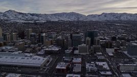 5.5K aerial stock footage passing Downtown Salt Lake City and Salt Palace with winter snow at sunrise in Utah Aerial Stock Footage | AX124_207E