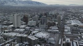 5.5K aerial stock footage of Salt Lake Temple and downtown buildings in snowy Salt Lake City at sunrise, Utah Aerial Stock Footage | AX124_222